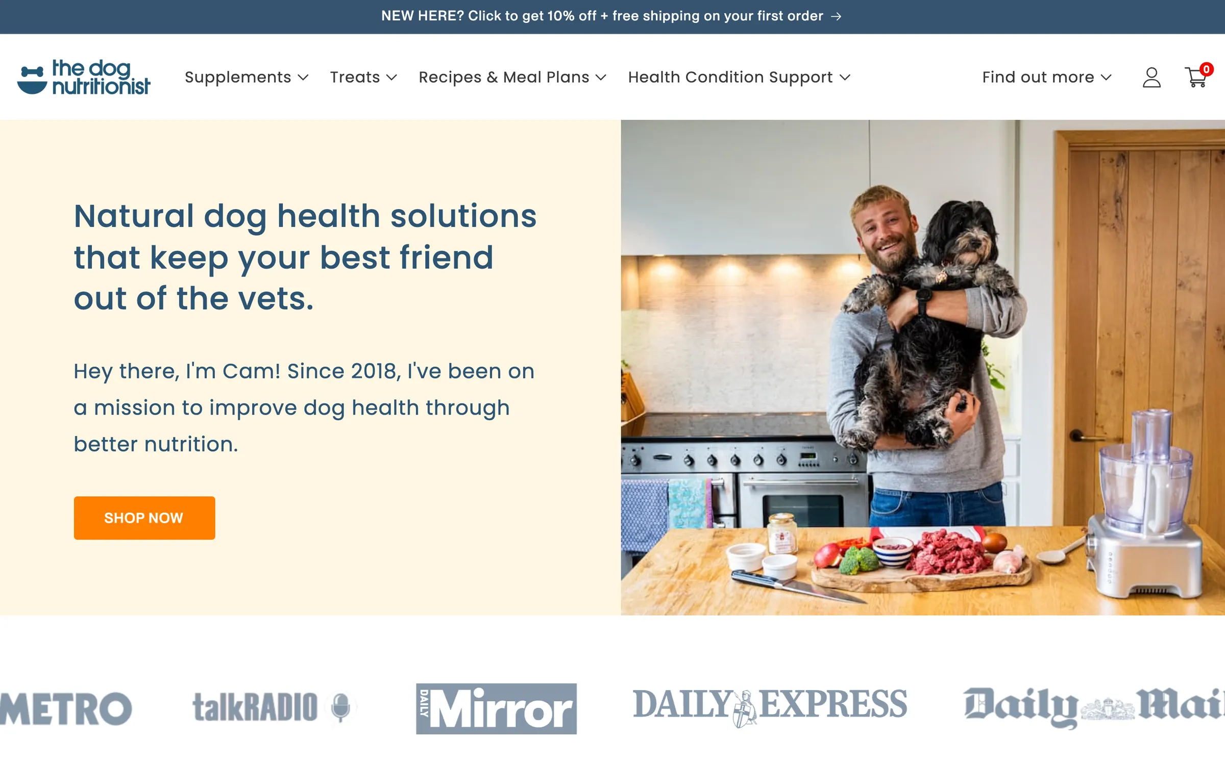 The Dog Nutritionist homepage: Natural dog health solutions that keep your best friend out of the vets, beside a photo of Cam holding his dog in a kitchen